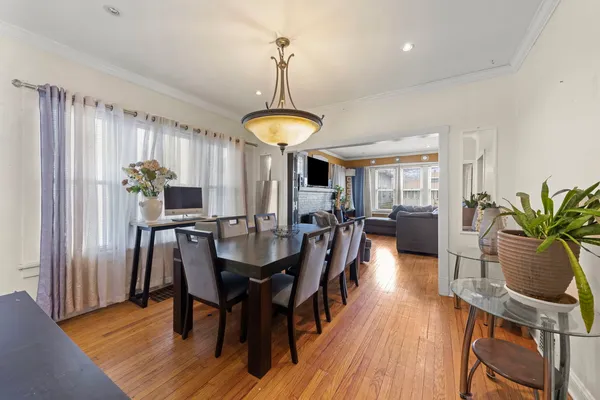 a view of a a dining room with furniture window and wooden floor