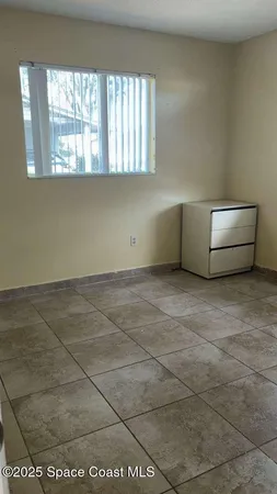 a view of an empty room with a window