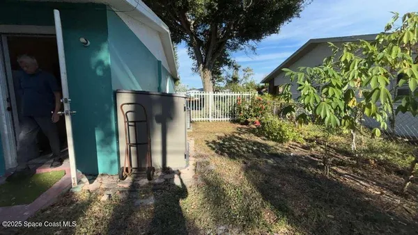 a backyard of a house with yard and outdoor seating