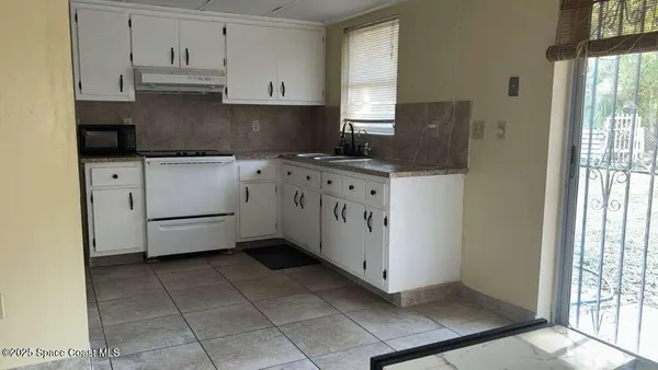 a kitchen with cabinets and window