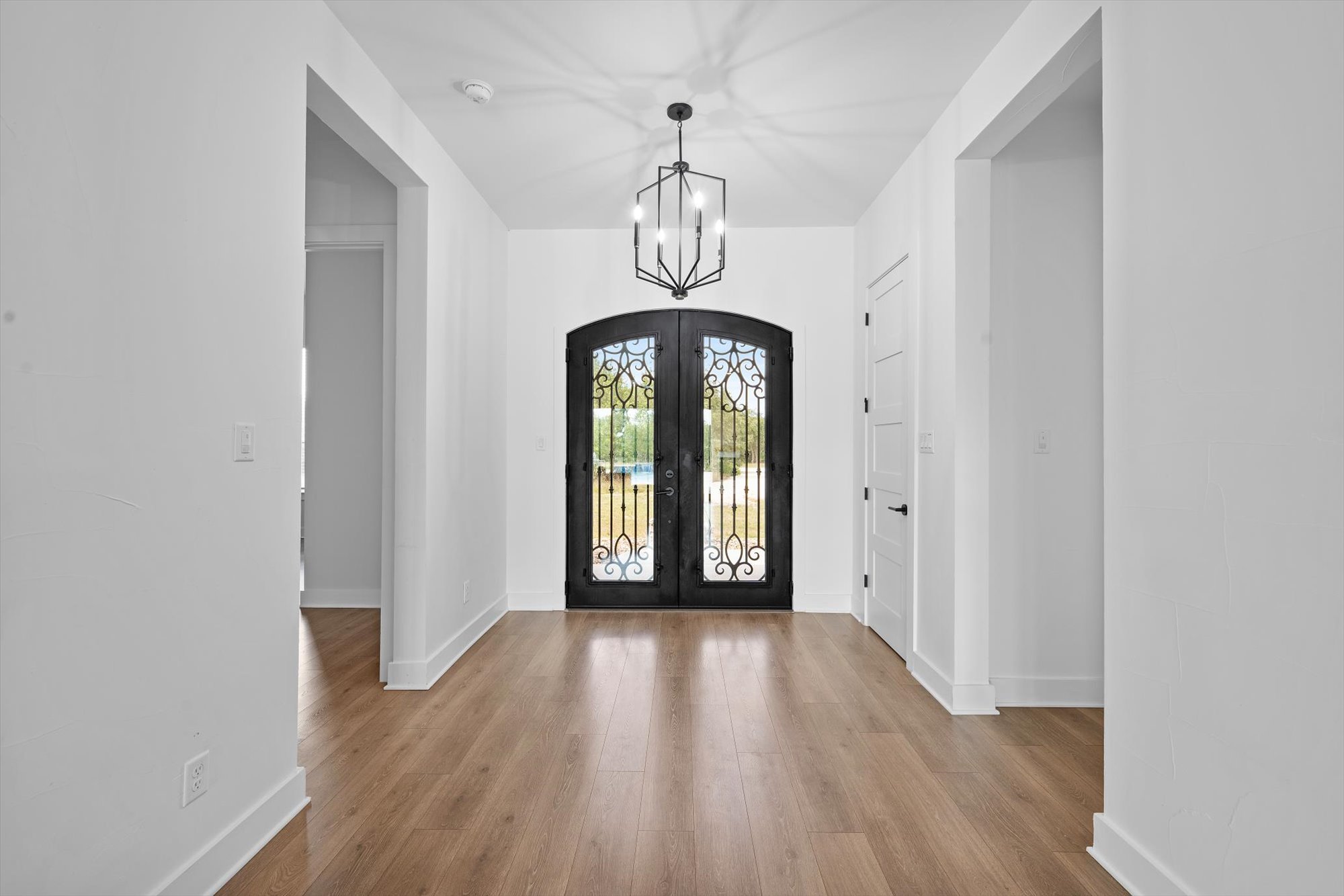 638 Strada Luca Florence, TX 76527 - Photo 27 of 38 Ornate wrought iron doors welcome you into a bright entry with warm hardwood flooring.