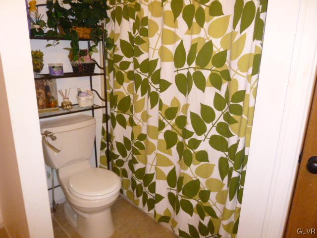 268 Sundance Road Effort, PA 18330 - Photo 12 of 28 a white toilet sitting next to a shower curtain