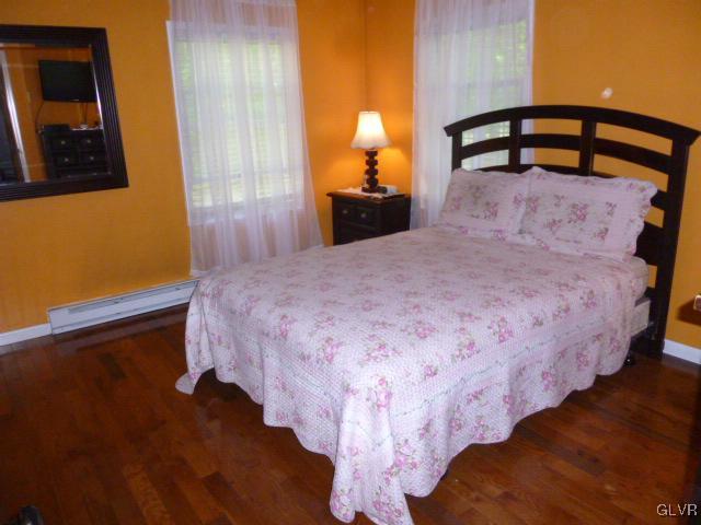 268 Sundance Road Effort, PA 18330 - Photo 16 of 28 a bedroom with a bed and wooden floor
