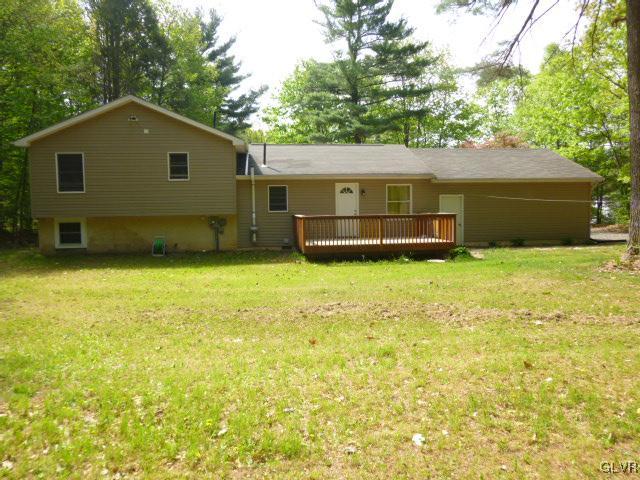 268 Sundance Road Effort, PA 18330 - Photo 24 of 28 a front view of house with yard and trees in the background