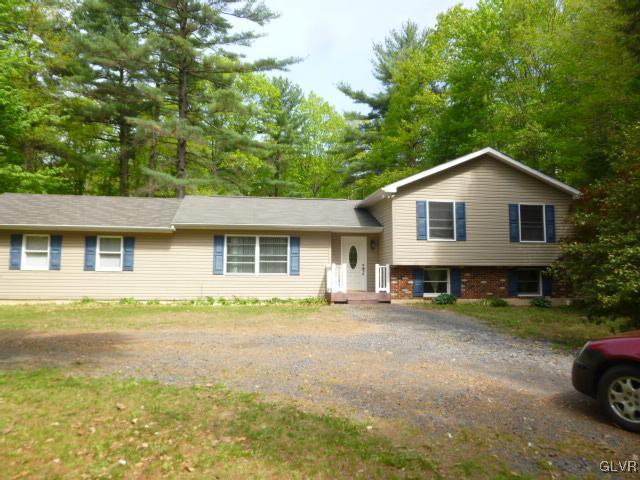 268 Sundance Road Effort, PA 18330 - Photo 28 of 28 a front view of a house with a garden and trees
