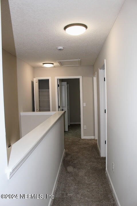 4152 Quiet Creek Loop, Unit 134 Middleburg, FL 32068 - Photo 11 of 42 a view of a hallway with wooden cabinets