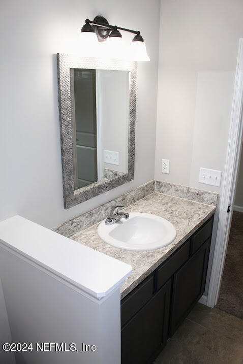 4152 Quiet Creek Loop, Unit 134 Middleburg, FL 32068 - Photo 17 of 42 a bathroom with a sink and a mirror