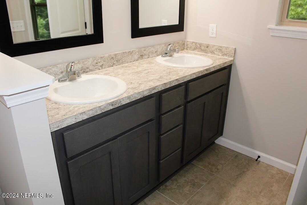 4152 Quiet Creek Loop, Unit 134 Middleburg, FL 32068 - Photo 20 of 42 a bathroom with a sink and a mirror