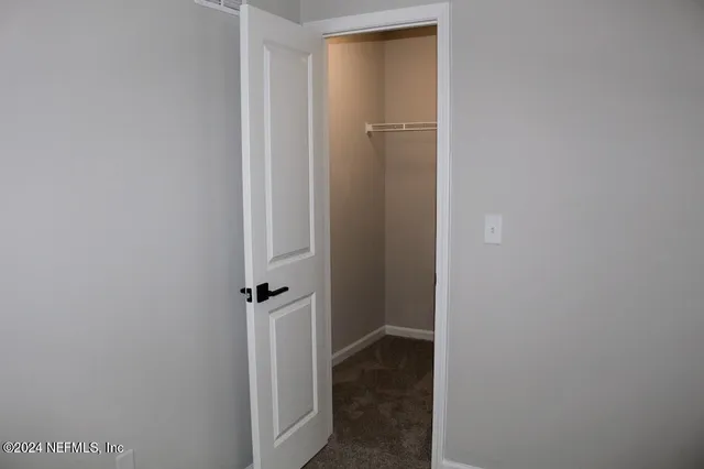 a view of a hallway with closet
