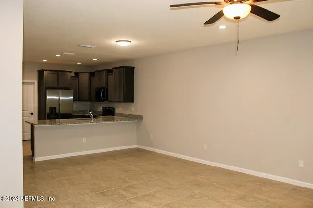 a view of a kitchen with a sink and a refrigerator