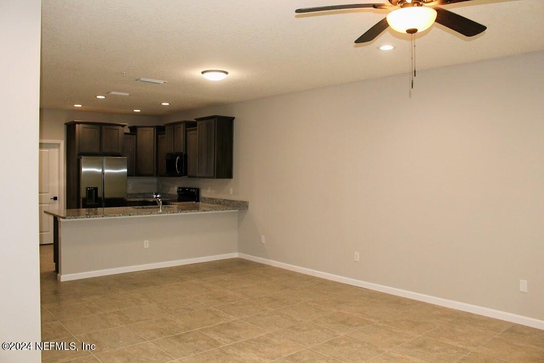 4152 Quiet Creek Loop, Unit 134 Middleburg, FL 32068 - Photo 30 of 42 a view of a kitchen with a sink and a refrigerator
