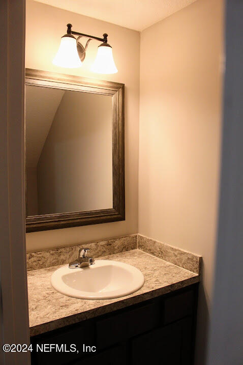 4152 Quiet Creek Loop, Unit 134 Middleburg, FL 32068 - Photo 32 of 42 a bathroom with a sink and a mirror