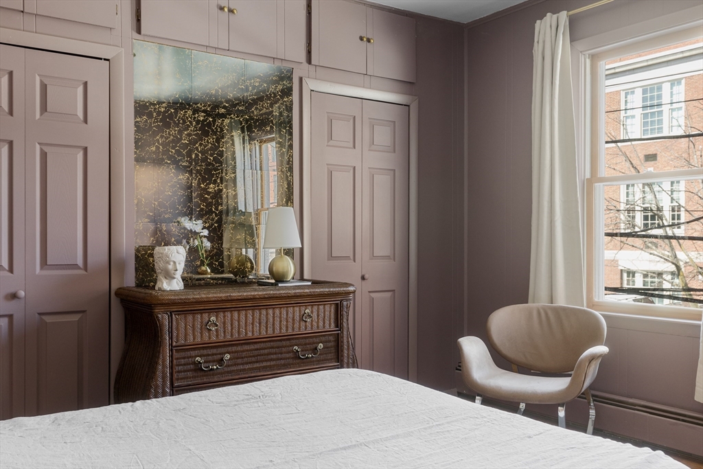 56 Spring Street, Unit 56 Cambridge, MA 02141 - Photo 11 of 14 a bedroom with a bed and wooden floor