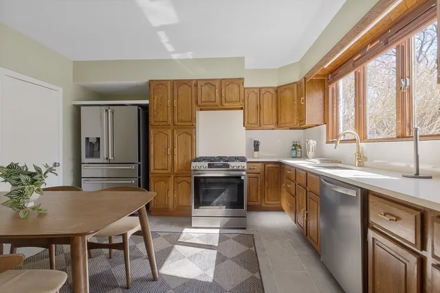 a kitchen with a stove a sink and a refrigerator
