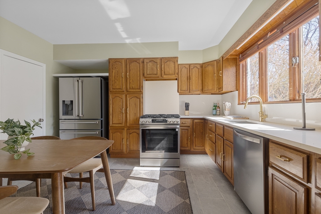56 Spring Street, Unit 56 Cambridge, MA 02141 - Photo 8 of 14 a kitchen with a stove a sink and a refrigerator