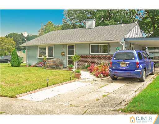123 Winthrop Road Edison, NJ 08817 - Photo 1 of 22 a front view of a house with a garden and fire pit