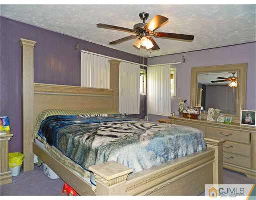 123 Winthrop Road Edison, NJ 08817 - Photo 11 of 22 a bedroom with a bed and ceiling fan