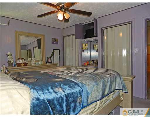 123 Winthrop Road Edison, NJ 08817 - Photo 13 of 22 a bedroom with a bed and a chandelier