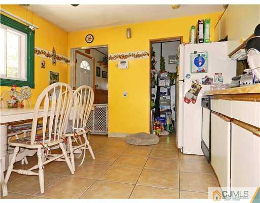 123 Winthrop Road Edison, NJ 08817 - Photo 6 of 22 a view of a kitchen with fridge and workspace