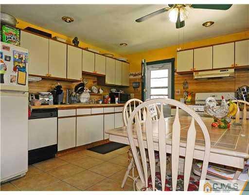 123 Winthrop Road Edison, NJ 08817 - Photo 7 of 22 a kitchen with stainless steel appliances kitchen island granite countertop a sink a stove cabinets and living room view