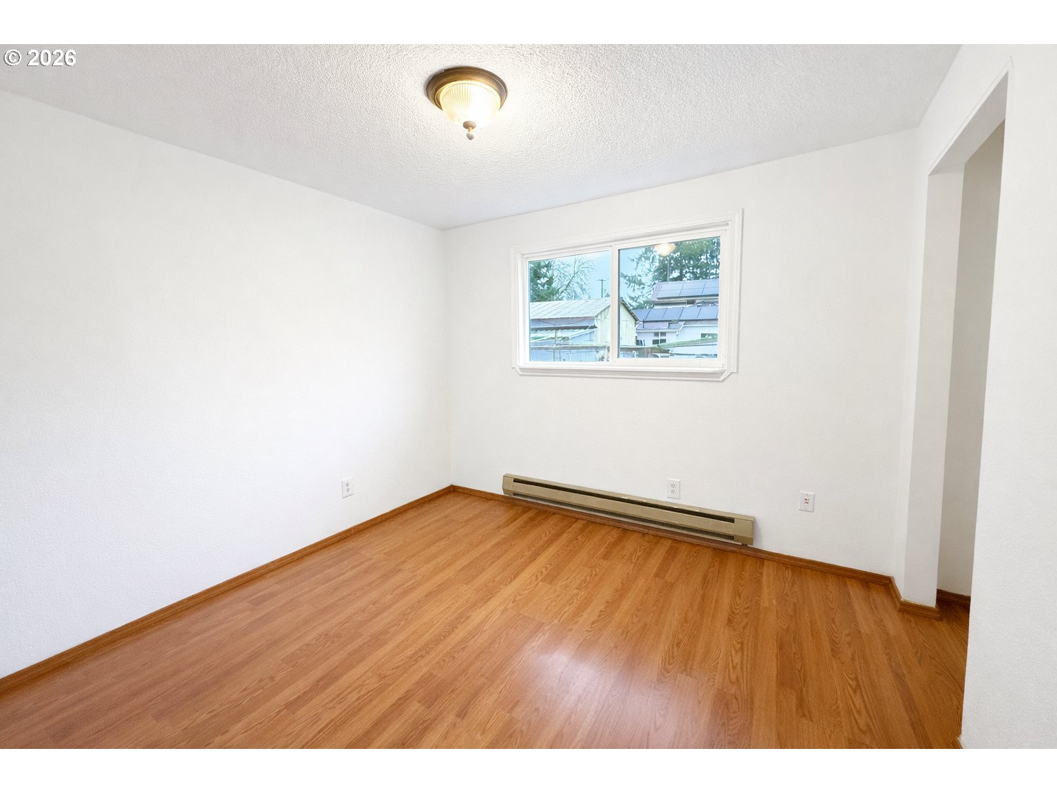 200 Roth Avenue Amity, OR 97101 - Photo 11 of 13 a view of an empty room with a window and wooden floor