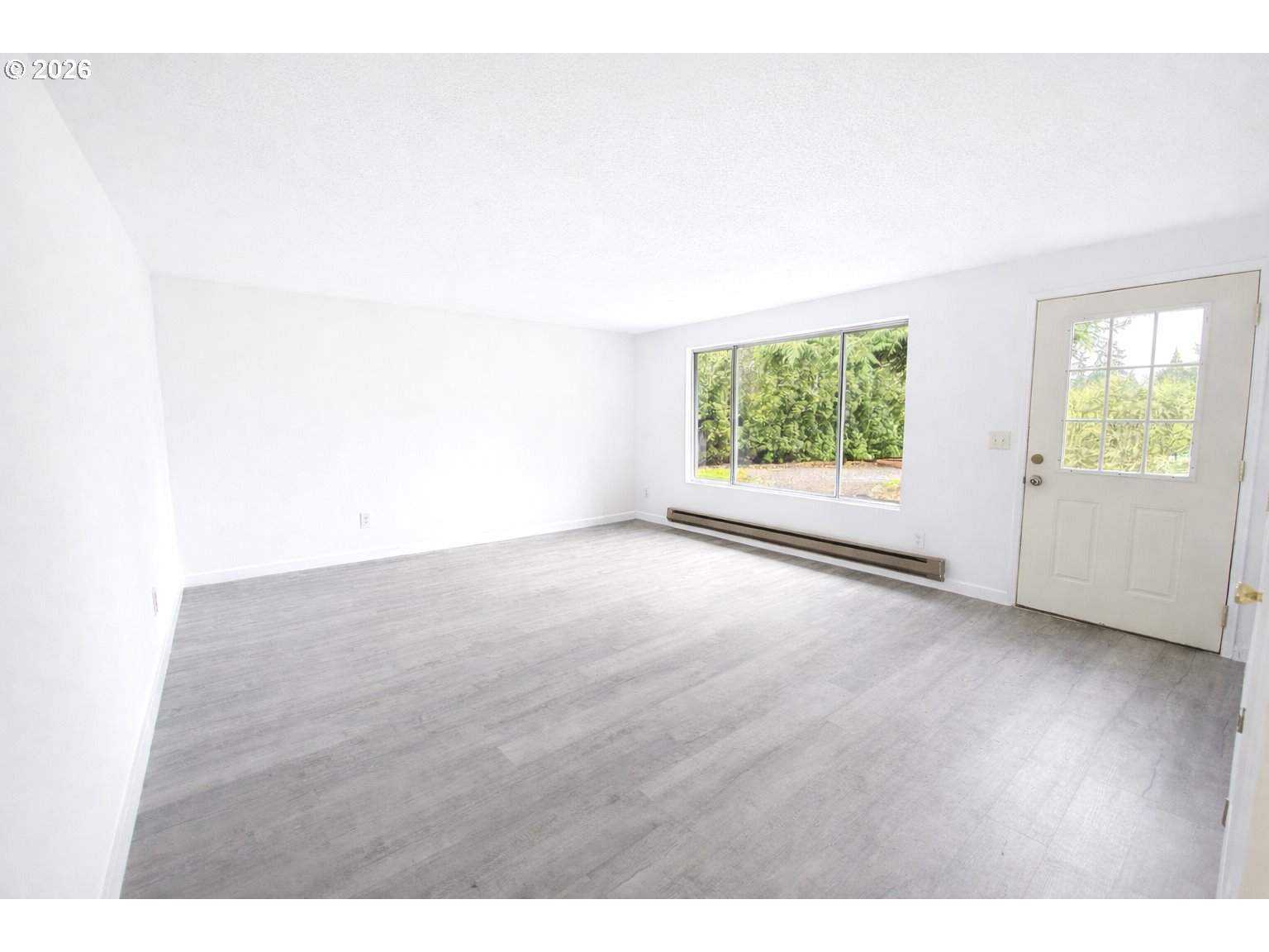 200 Roth Avenue Amity, OR 97101 - Photo 4 of 13 a view of an empty room with wooden floor and a window