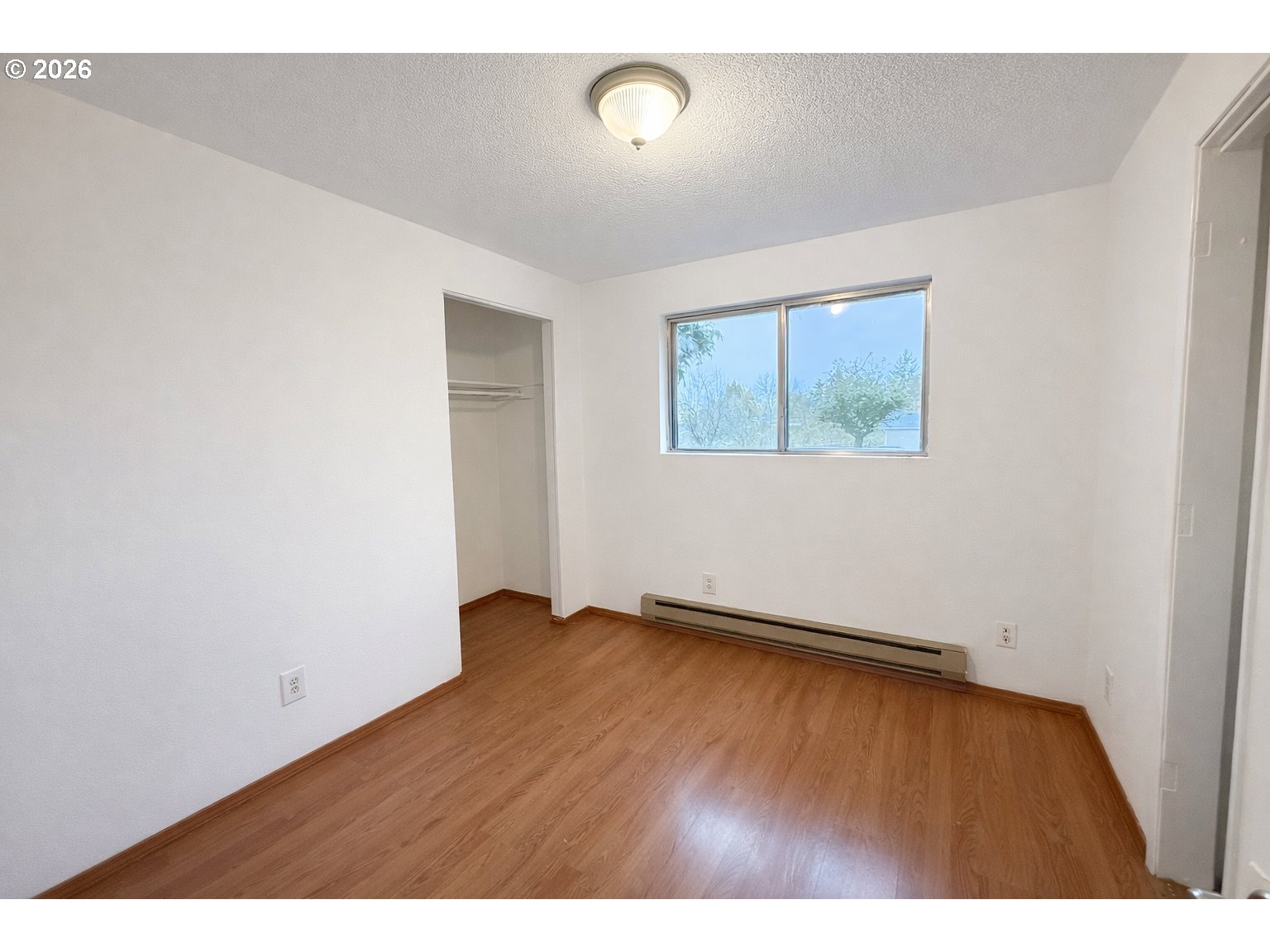 200 Roth Avenue Amity, OR 97101 - Photo 9 of 13 an empty room with wooden floor and windows