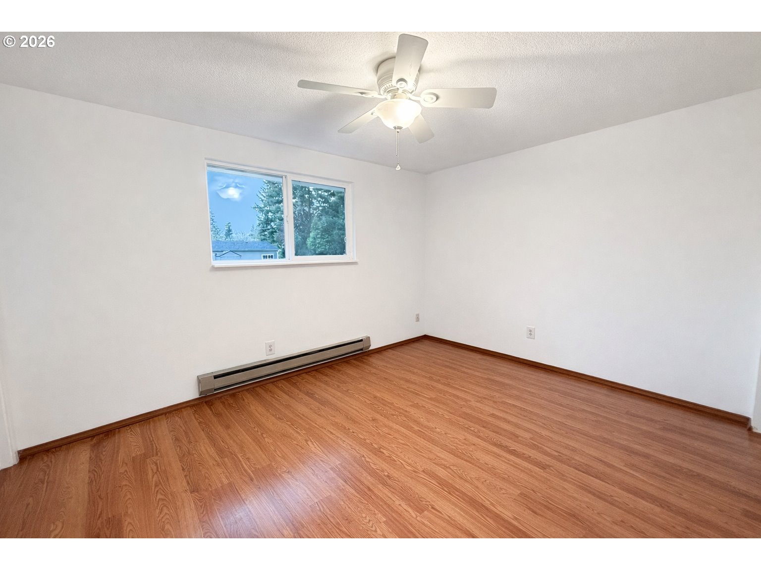 200 Roth Avenue Amity, OR 97101 - Photo 10 of 13 an empty room with wooden floor and windows