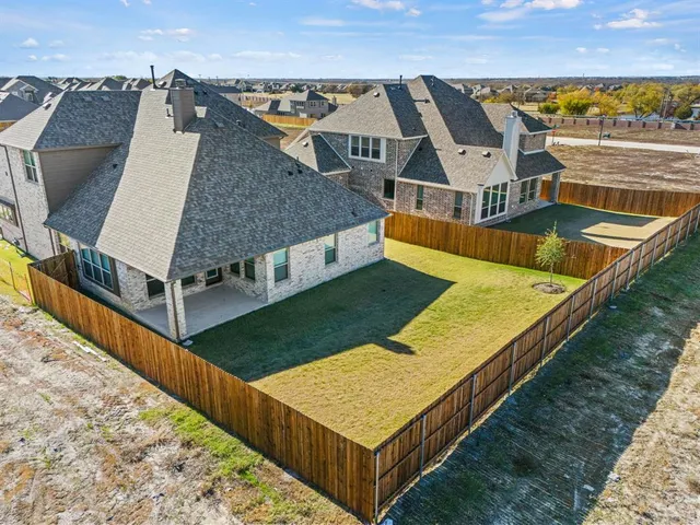 an aerial view of a house with a swimming pool