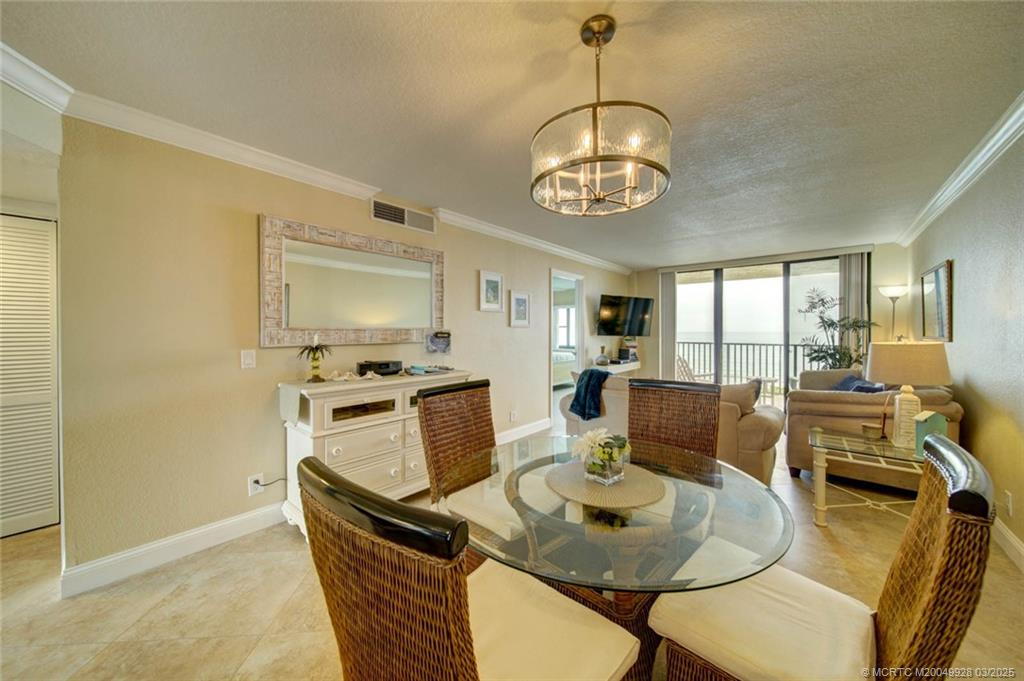 7380 South Ocean Drive, Unit 320 Jensen Beach, FL 34957 - Photo 12 of 39 a living room with dining table and chairs