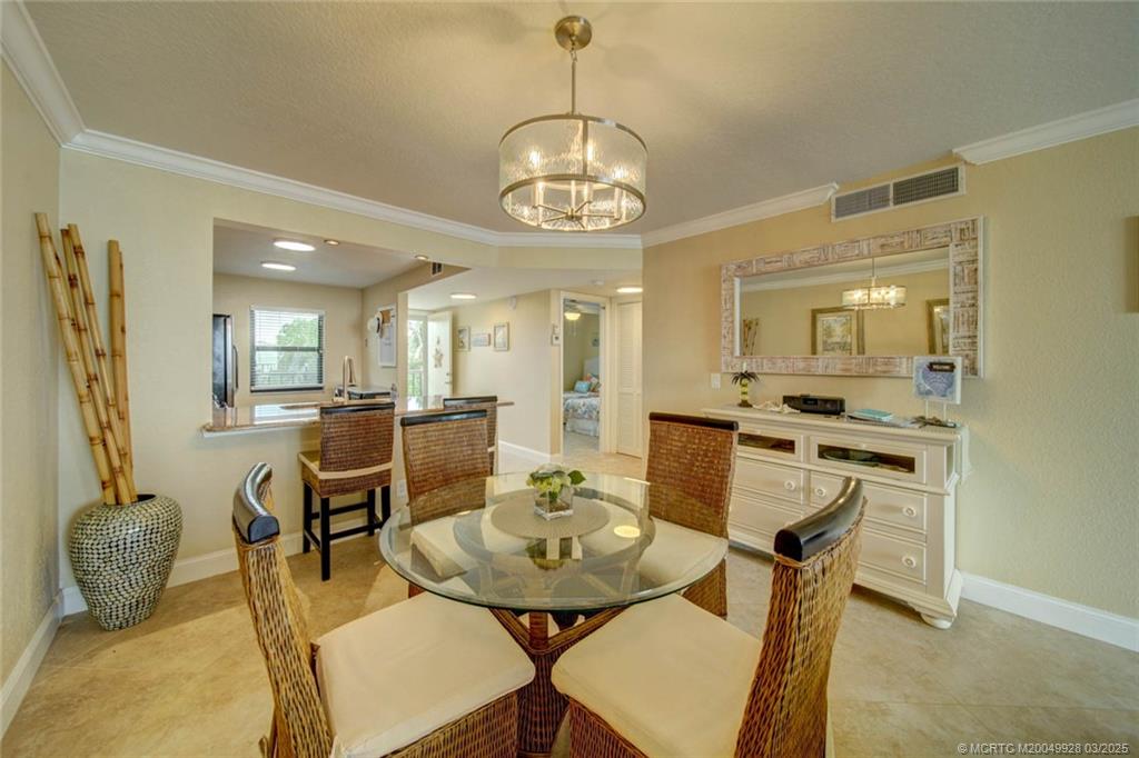 7380 South Ocean Drive, Unit 320 Jensen Beach, FL 34957 - Photo 13 of 39 a view of a dining room with furniture and a chandelier