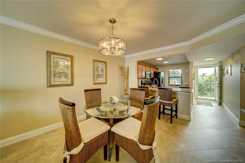 7380 South Ocean Drive, Unit 320 Jensen Beach, FL 34957 - Photo 14 of 39 a view of a dining room with furniture and wooden floor