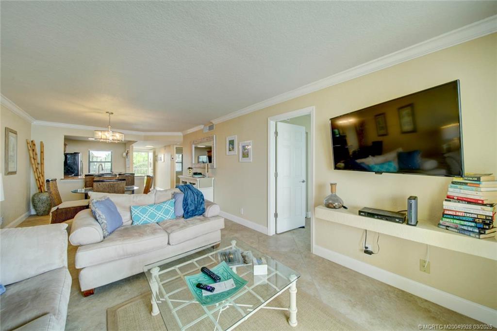 7380 South Ocean Drive, Unit 320 Jensen Beach, FL 34957 - Photo 17 of 39 a living room with furniture and a flat screen tv