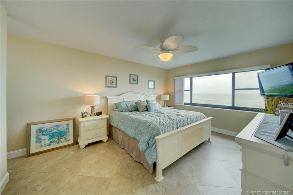 7380 South Ocean Drive, Unit 320 Jensen Beach, FL 34957 - Photo 19 of 39 a bedroom with a bed and a large window