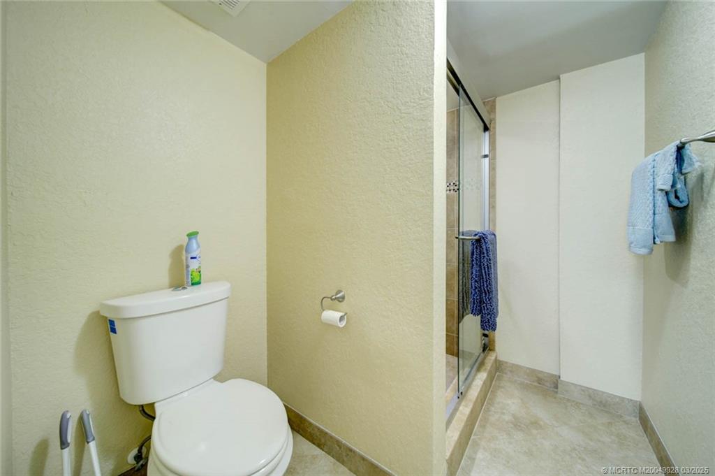 7380 South Ocean Drive, Unit 320 Jensen Beach, FL 34957 - Photo 24 of 39 a white toilet sitting next to a bathroom sink