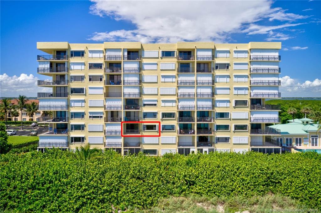 7380 South Ocean Drive, Unit 320 Jensen Beach, FL 34957 - Photo 5 of 39 a front view of a building with a yard