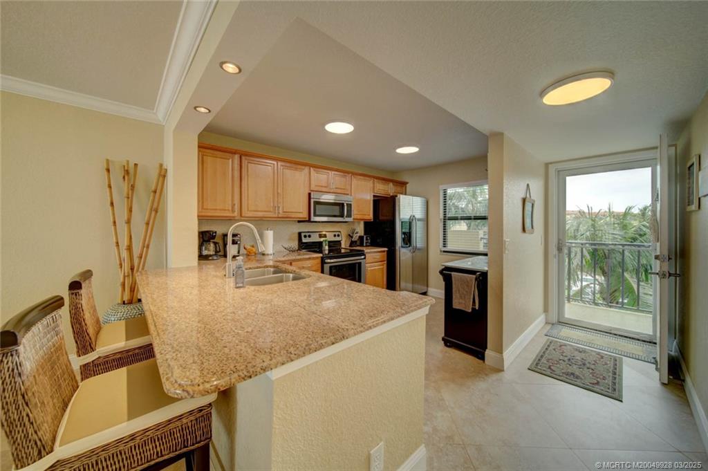 7380 South Ocean Drive, Unit 320 Jensen Beach, FL 34957 - Photo 6 of 39 a view of kitchen with furniture and refrigerator