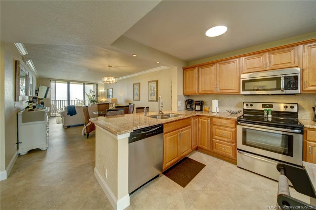 7380 South Ocean Drive, Unit 320 Jensen Beach, FL 34957 - Photo 7 of 39 a kitchen with a sink and steel appliances