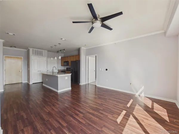 a view of a kitchen with wooden floor and a sink
