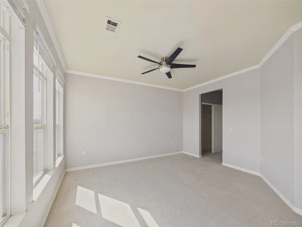 a view of a livingroom with a ceiling fan and window