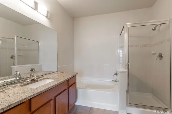 a bathroom with a granite countertop sink mirror and shower