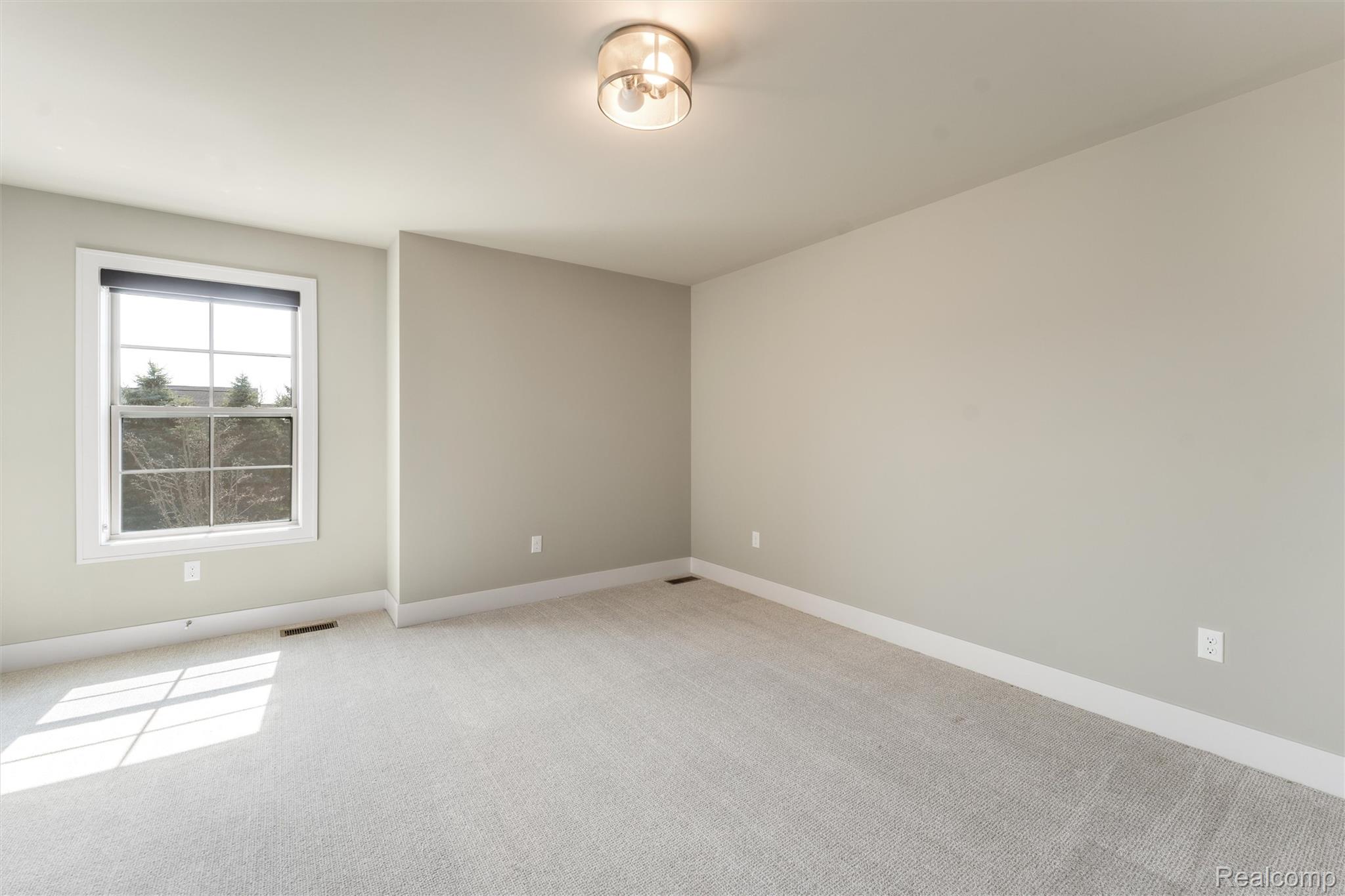 1040 Lamb Road, Unit # 5 Troy, MI 48085 - Photo 7 of 30 Unfurnished room featuring light colored carpet and baseboards