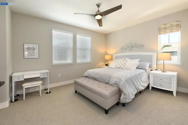 a bedroom with a bed and a table