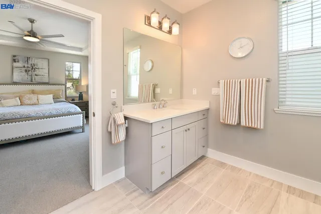 a spacious bathroom with a double vanity sink and a mirror