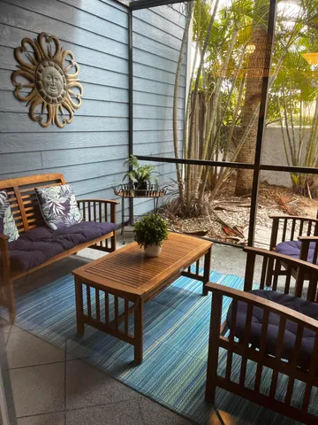 a view of a chairs and table in the balcony