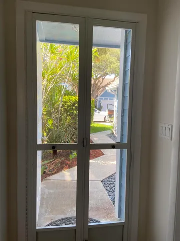 a view of a glass door with a lake view