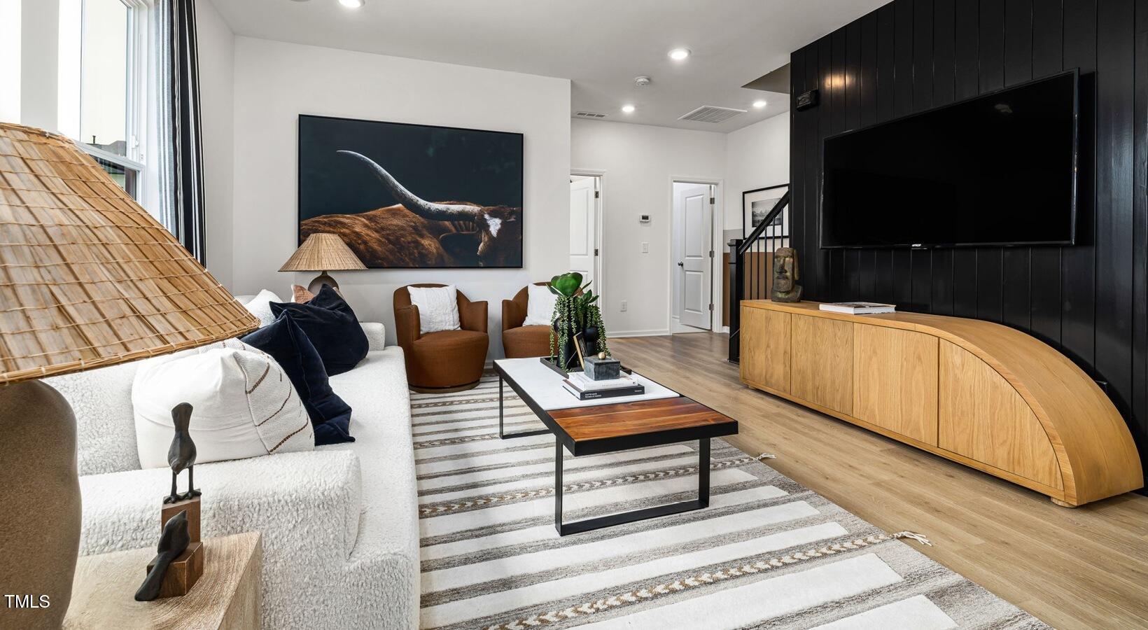 3709 Nova Star Lane, Unit GRADY Raleigh, NC 27612 - Photo 21 of 30 a living room with furniture and a flat screen tv