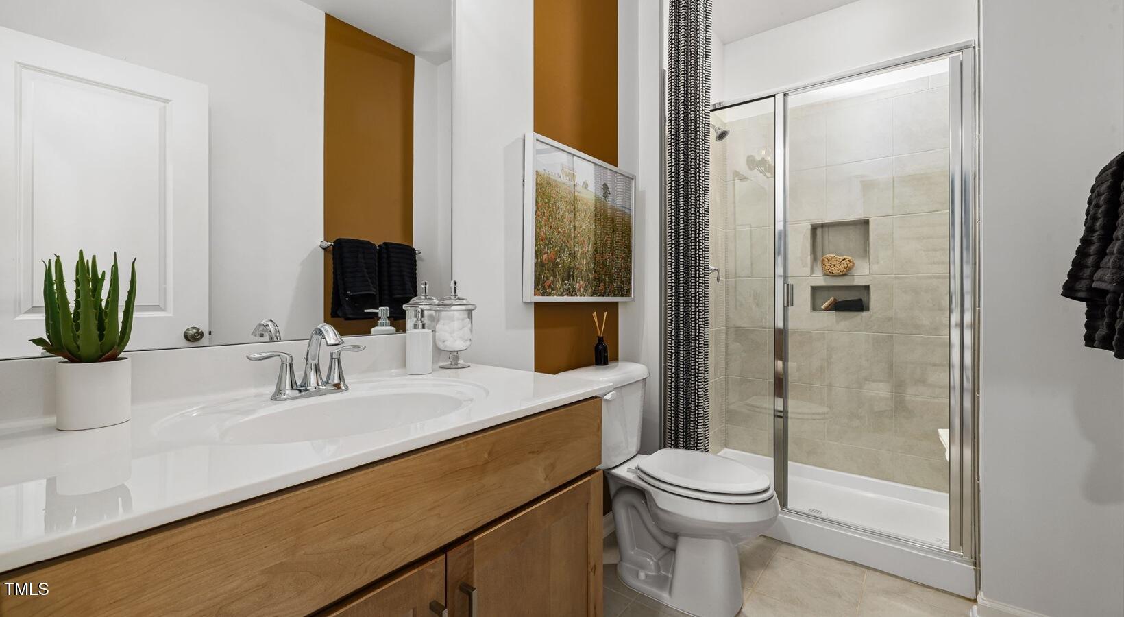 3709 Nova Star Lane, Unit GRADY Raleigh, NC 27612 - Photo 26 of 30 a bathroom with a sink a toilet and shower