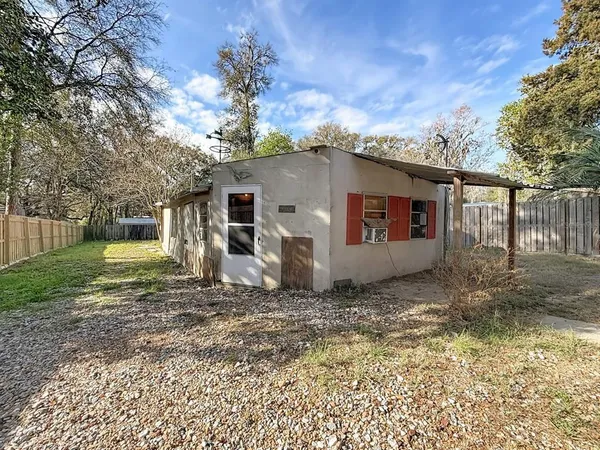 a view of a grey house with a yard
