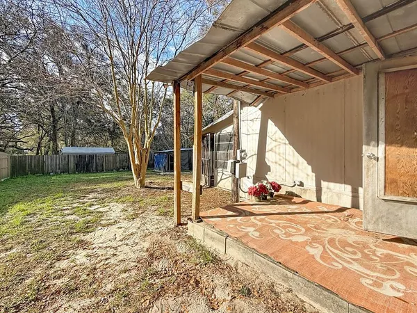a view of a couches in the patio with a barbeque